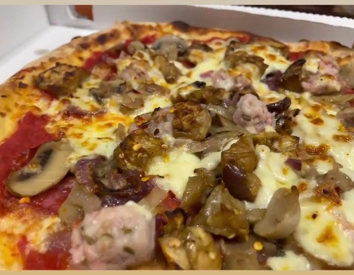 Pizza con salsiccia, funghi, melanzane e cipolla